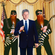 ZZ Top guitarists Billy Gibbons and Dusty Hill formally present President Clinton with the keys to the Eliminator hot rod.